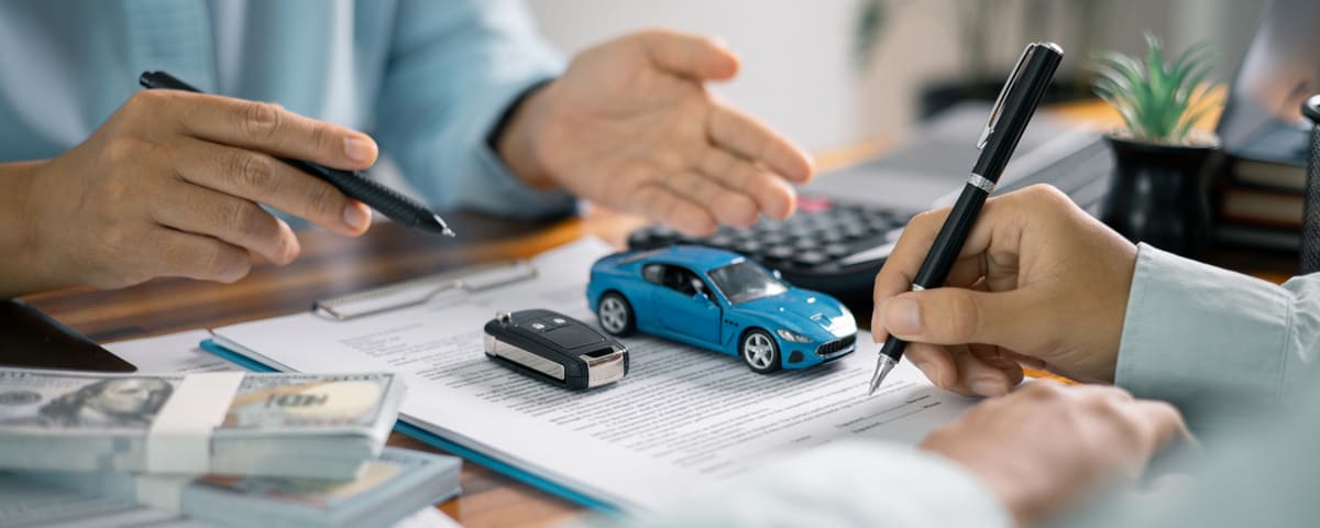 Une personne signe un contrat crédit auto avec un salaire minimum